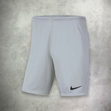 Nike Dri-Fit T-Shirt and Shorts Set in white and grey, featuring moisture-wicking fabric for comfort and a clean, athletic style.