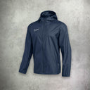 Nike Academy Rain Jacket in navy, featuring a water-resistant design for protection and comfort in wet conditions.