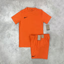 Nike Dri-FIT T-Shirt and Shorts Set in orange, featuring moisture-wicking fabric for comfort and breathability, with a relaxed-fit T-shirt and adjustable waistband shorts for a secure, athletic look.
